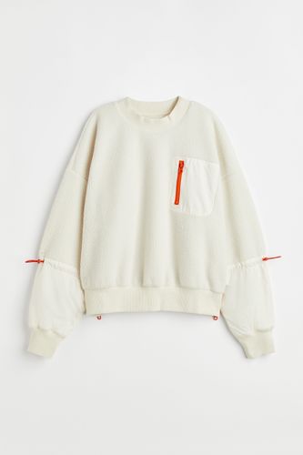 H&M+ Sport-Sweatshirt aus Teddyfleece Naturweiß/Orange